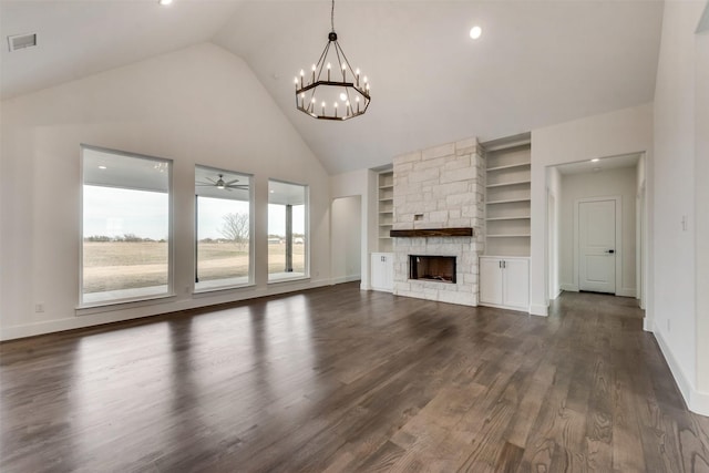 219 Mulkey Rd, Waxahachie, TX 75167 - unfurnished living room with a chandelier, built in features, baseboards, dark wood-style floors, and high vaulted ceiling