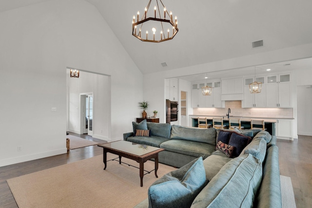 219 Mulkey Rd, Waxahachie, TX 75167 - living area featuring high vaulted ceiling, a chandelier, baseboards, and dark wood-style flooring