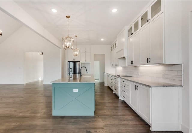 219 Mulkey Rd, Waxahachie, TX 75167 - kitchen with stainless steel fridge, black electric cooktop, backsplash, a chandelier, and recessed lighting
