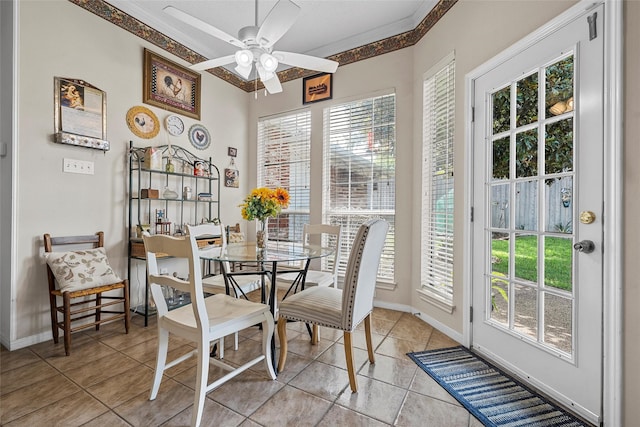 4215 Green Oak Dr, Waco, TX 76710 - dining area with ornamental molding, ceiling fan, baseboards, and light tile patterned flooring