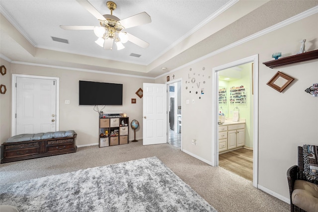 4215 Green Oak Dr, Waco, TX 76710 - bedroom featuring light colored carpet, a raised ceiling, crown molding, ensuite bath, and a ceiling fan