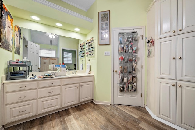 4215 Green Oak Dr, Waco, TX 76710 - bathroom with ornamental molding, vanity, wood finished floors, baseboards, and recessed lighting