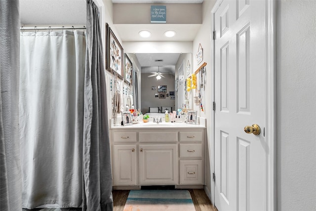 4215 Green Oak Dr, Waco, TX 76710 - bathroom featuring vanity, wood finished floors, and a ceiling fan