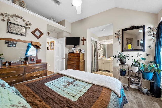 4215 Green Oak Dr, Waco, TX 76710 - bedroom featuring wood finished floors, vaulted ceiling, connected bathroom, and ceiling fan