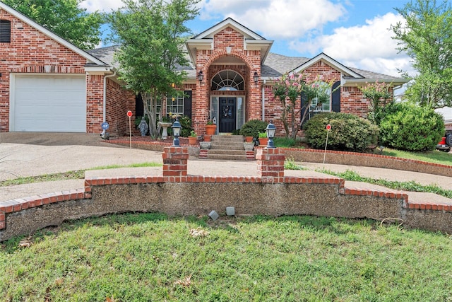 4215 Green Oak Dr, Waco, TX 76710 - traditional-style home featuring brick siding, concrete driveway, a garage, and roof with shingles