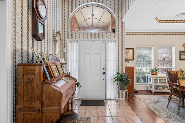 4215 Green Oak Dr, Waco, TX 76710 - entryway featuring wallpapered walls, baseboards, and ornamental molding