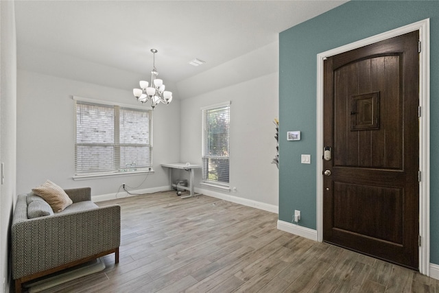 800 Marion Farm Rd E, Little Elm, TX 75068 - entryway featuring a chandelier, wood finished floors, baseboards, and lofted ceiling