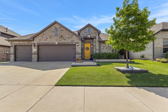 800 Marion Farm Rd E, Little Elm, TX 75068 - french country style house with an attached garage, a front yard, concrete driveway, and stone siding