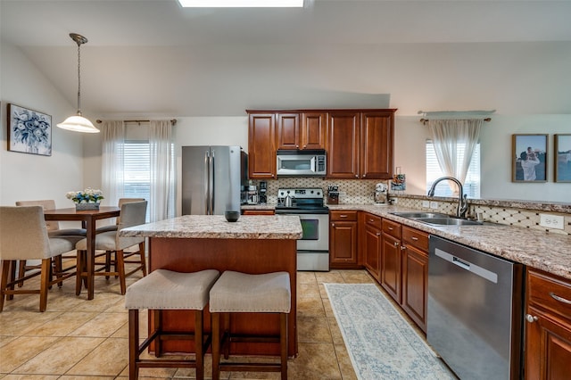 2813 Ashton Way, Mckinney, TX 75071 - kitchen with stainless steel appliances, a sink, plenty of natural light, tasteful backsplash, and vaulted ceiling