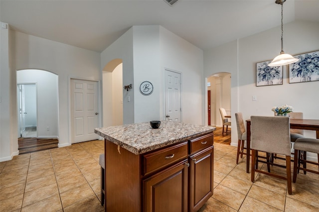 2813 Ashton Way, Mckinney, TX 75071 - kitchen featuring arched walkways, light tile patterned flooring, pendant lighting, and high vaulted ceiling