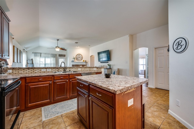 2813 Ashton Way, Mckinney, TX 75071 - kitchen featuring arched walkways, a sink, stainless steel appliances, a ceiling fan, and light tile patterned flooring