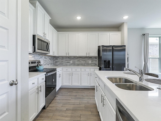 3019 Dakota Trl, Crandall, TX 75114 - kitchen featuring stainless steel appliances, a sink, light countertops, white cabinetry, and recessed lighting
