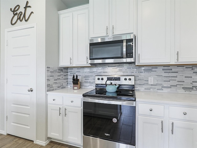 3019 Dakota Trl, Crandall, TX 75114 - kitchen featuring appliances with stainless steel finishes, decorative backsplash, light countertops, white cabinets, and light wood-type flooring