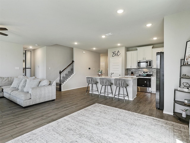 3019 Dakota Trl, Crandall, TX 75114 - living room featuring dark wood-type flooring, stairs, baseboards, recessed lighting, and a ceiling fan