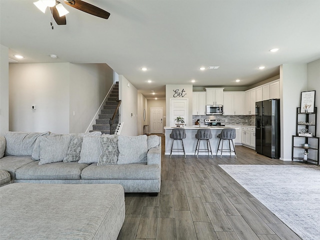 3019 Dakota Trl, Crandall, TX 75114 - living room with dark wood-type flooring, stairway, a ceiling fan, and recessed lighting