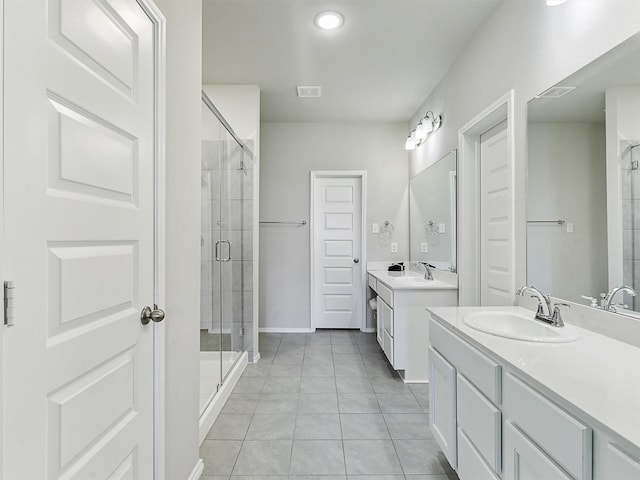 3019 Dakota Trl, Crandall, TX 75114 - bathroom with tile patterned flooring, a stall shower, two vanities, and baseboards