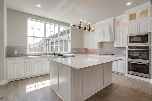 604 Bluff Point Ln, Haslet, TX 76052 - kitchen featuring built in microwave, stainless steel double oven, a chandelier, healthy amount of natural light, and recessed lighting