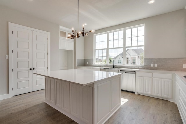 604 Bluff Point Ln, Haslet, TX 76052 - kitchen featuring dishwasher, tasteful backsplash, a chandelier, light wood-style flooring, and recessed lighting