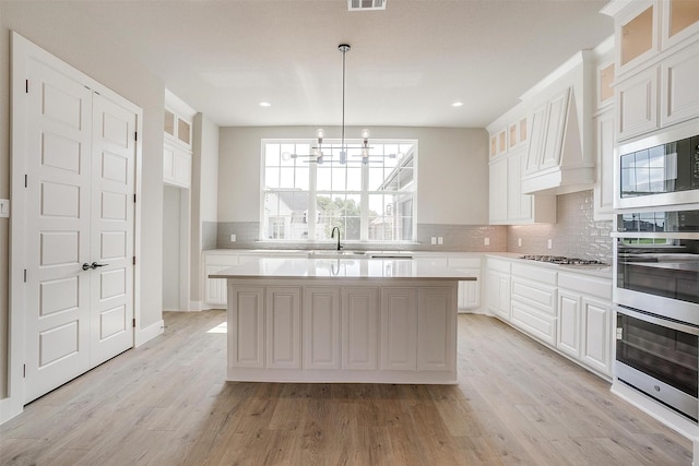 604 Bluff Point Ln, Haslet, TX 76052 - kitchen with a sink, stainless steel appliances, light countertops, decorative backsplash, and recessed lighting