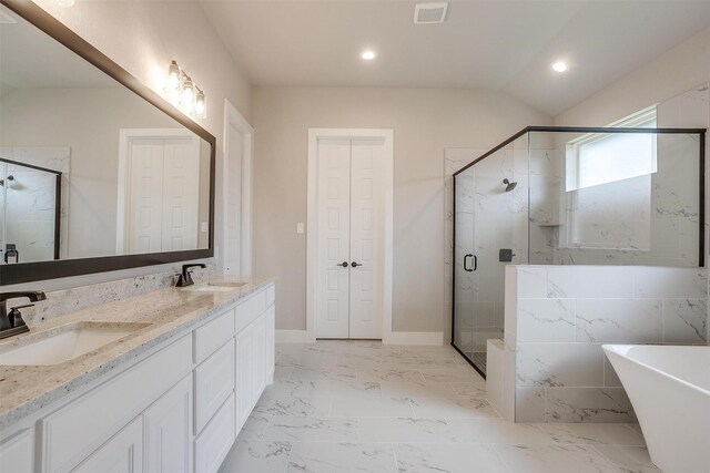 604 Bluff Point Ln, Haslet, TX 76052 - bathroom featuring double vanity, a freestanding bath, a shower stall, recessed lighting, and baseboards