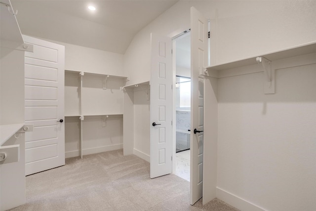 604 Bluff Point Ln, Haslet, TX 76052 - walk in closet with light carpet and lofted ceiling