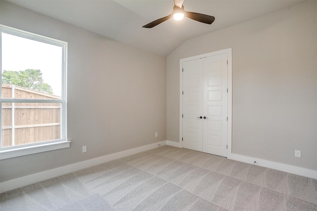 604 Bluff Point Ln, Haslet, TX 76052 - spare room featuring a ceiling fan, light colored carpet, vaulted ceiling, and baseboards