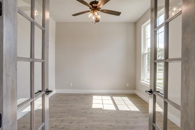 604 Bluff Point Ln, Haslet, TX 76052 - empty room with french doors, healthy amount of natural light, and light wood-type flooring