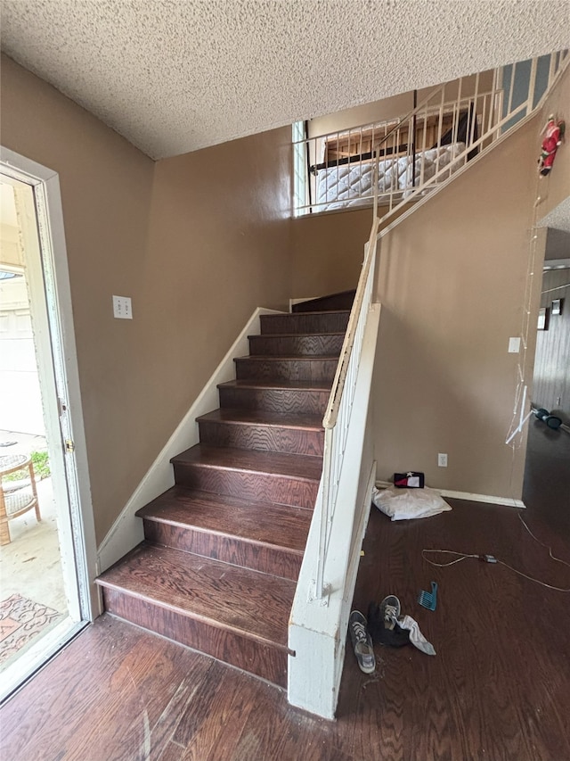 701 Rocky Canyon Rd, Arlington, TX 76012 - stairway with wood finished floors, a textured ceiling, and baseboards