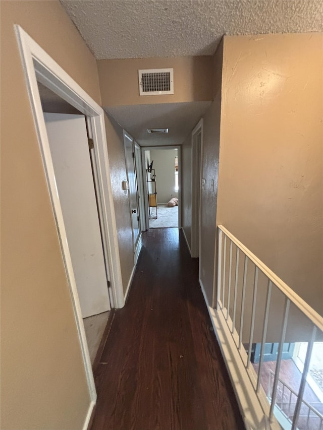 701 Rocky Canyon Rd, Arlington, TX 76012 - hallway with wood finished floors, a textured ceiling, and baseboards