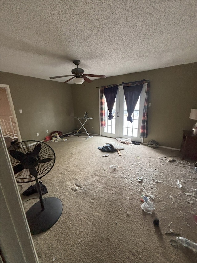 701 Rocky Canyon Rd, Arlington, TX 76012 - unfurnished living room with french doors, a textured ceiling, ceiling fan, and carpet flooring