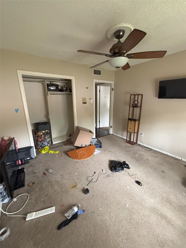 701 Rocky Canyon Rd, Arlington, TX 76012 - unfurnished bedroom featuring carpet flooring, a textured ceiling, a closet, a ceiling fan, and baseboards