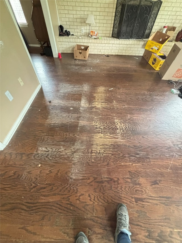701 Rocky Canyon Rd, Arlington, TX 76012 - detailed view of wood finished floors, baseboards, and brick wall