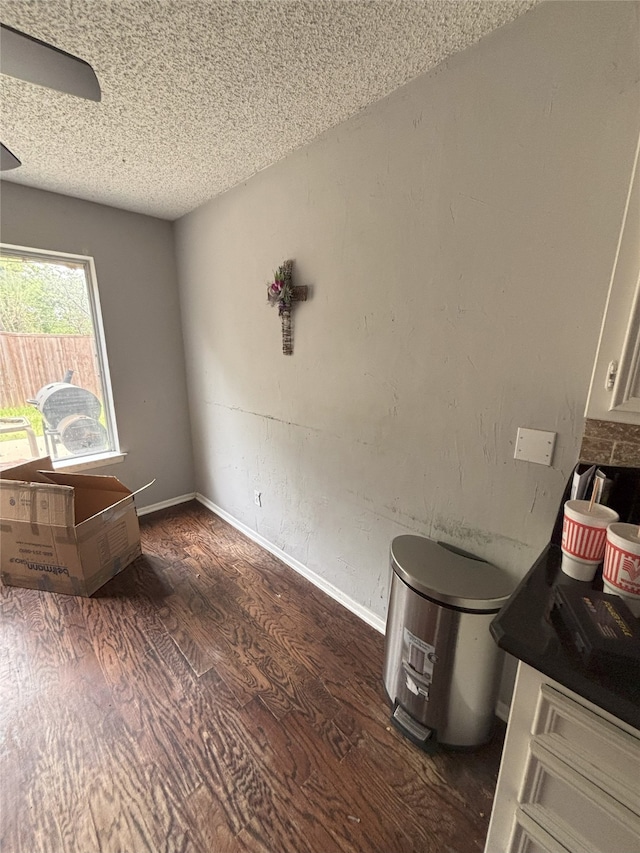 701 Rocky Canyon Rd, Arlington, TX 76012 - spare room with wood finished floors, a textured ceiling, and baseboards