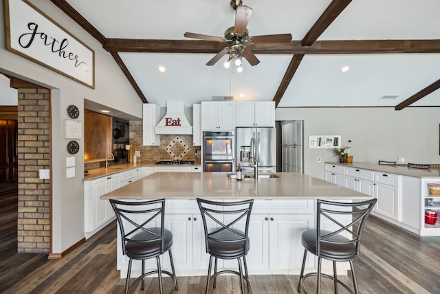 108 Circleview Dr S, Hurst, TX 76054 - kitchen featuring appliances with stainless steel finishes, custom range hood, decorative backsplash, dark wood-style flooring, and a sink