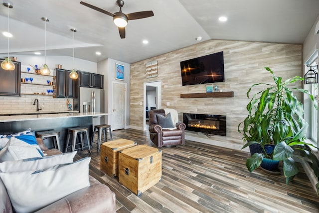108 Circleview Dr S, Hurst, TX 76054 - living room with vaulted ceiling, ceiling fan, wood finished floors, a tile fireplace, and recessed lighting