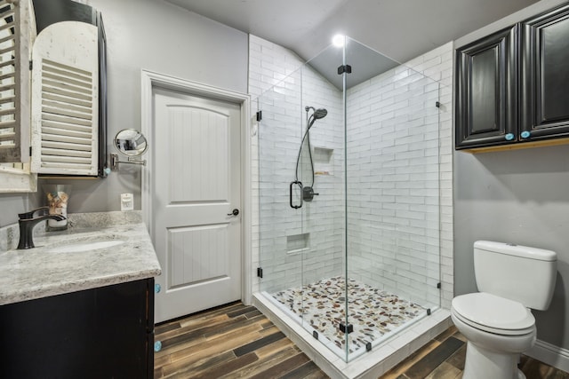 108 Circleview Dr S, Hurst, TX 76054 - bathroom featuring wood finished floors, a stall shower, vanity, toilet, and lofted ceiling
