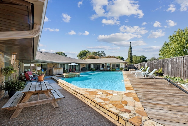 108 Circleview Dr S, Hurst, TX 76054 - view of swimming pool featuring a pool with connected hot tub, a fenced backyard, a patio, and a deck