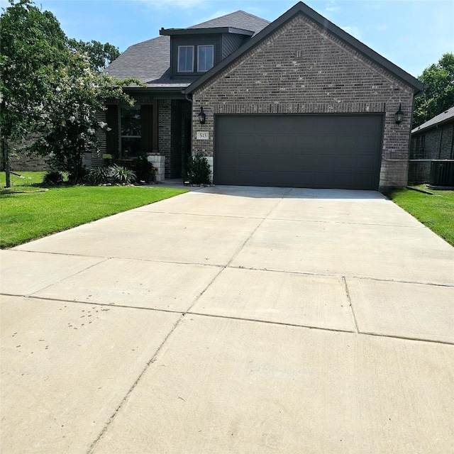 543 Remington Way, Wylie, TX 75098 - view of front of house with brick siding, a front yard, cooling unit, and a garage