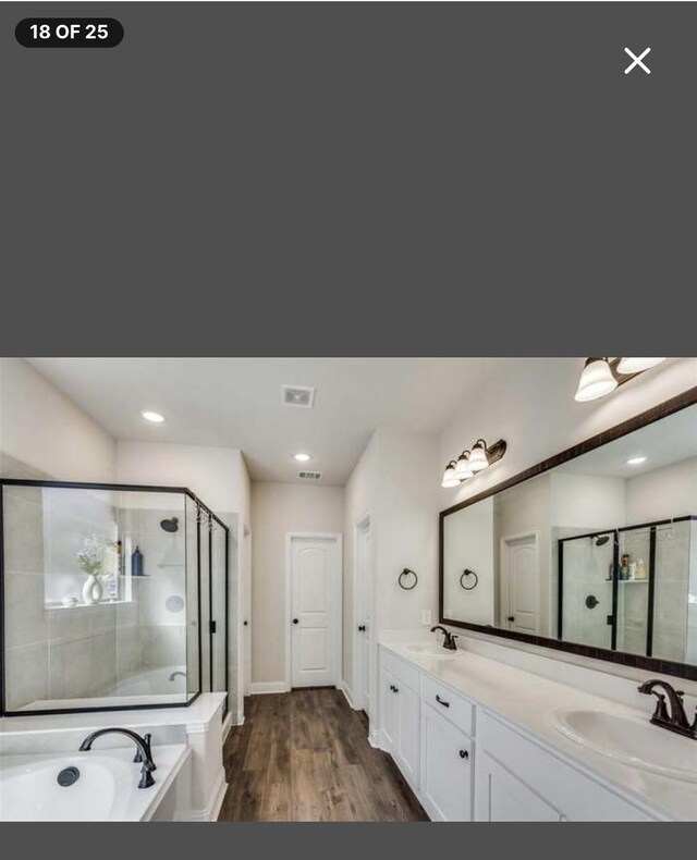 543 Remington Way, Wylie, TX 75098 - bathroom with ensuite bath, a bath, double vanity, wood finished floors, and baseboards