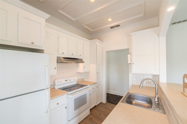 101 S Walnut St, Petrolia, TX 76377 - kitchen with white appliances, a sink, under cabinet range hood, backsplash, and light countertops