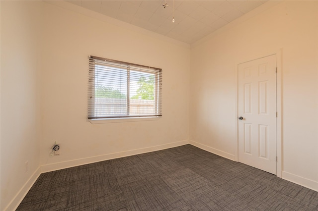 101 S Walnut St, Petrolia, TX 76377 - empty room with dark carpet and baseboards