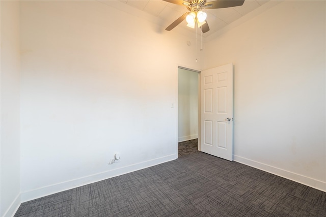 101 S Walnut St, Petrolia, TX 76377 - spare room featuring dark colored carpet, ceiling fan, and baseboards