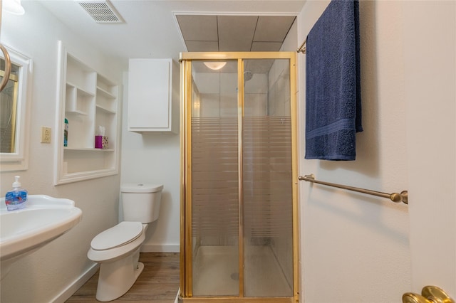 101 S Walnut St, Petrolia, TX 76377 - full bath with toilet, a shower stall, wood finished floors, and built in features