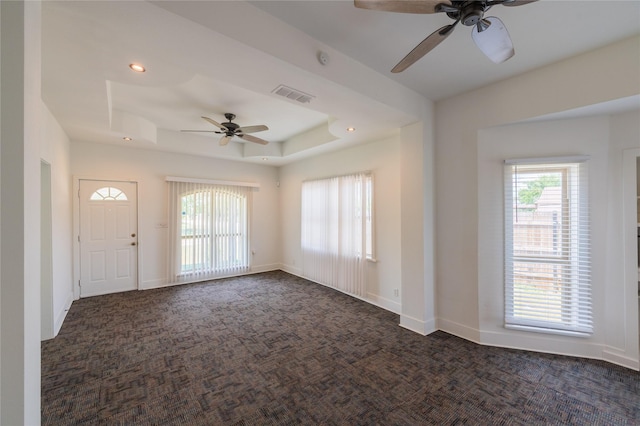 101 S Walnut St, Petrolia, TX 76377 - entryway with ceiling fan, dark colored carpet, a raised ceiling, recessed lighting, and baseboards