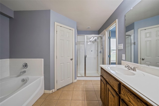 105 Universal Dr, Fate, TX 75189 - full bath featuring tile patterned floors, vanity, a stall shower, a garden tub, and baseboards