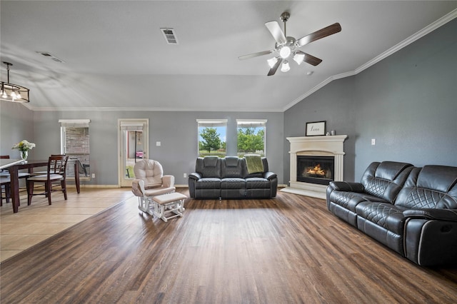 105 Universal Dr, Fate, TX 75189 - living room with wood finished floors, ceiling fan, a warm lit fireplace, a chandelier, and lofted ceiling