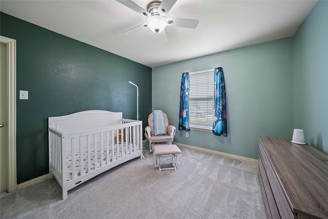 105 Universal Dr, Fate, TX 75189 - bedroom featuring carpet flooring, ceiling fan, baseboards, and a nursery area
