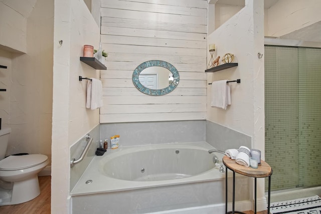 3044 US Highway 80, Grand Saline, TX 75140 - full bathroom with toilet, a tub with jets, a stall shower, and wood finished floors
