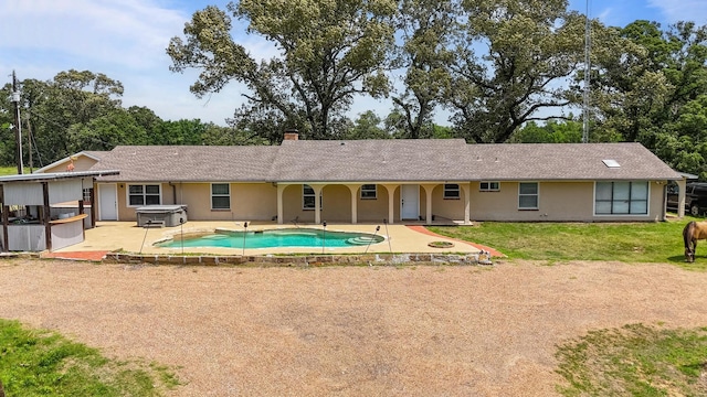 3044 US Highway 80, Grand Saline, TX 75140 - back of house featuring a hot tub, a patio area, a chimney, an outdoor pool, and stucco siding