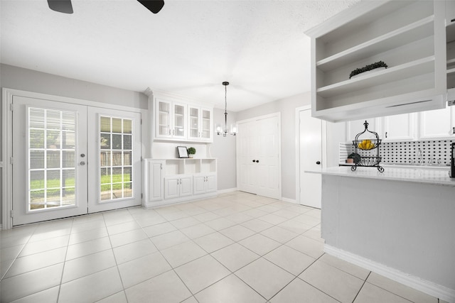 543 S Oldbridge Dr, Allen, TX 75002 - kitchen featuring light countertops, white cabinetry, light tile patterned floors, and glass insert cabinets